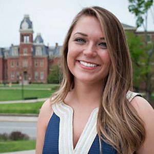 Headshot of emily with Woodburn Hall in the background