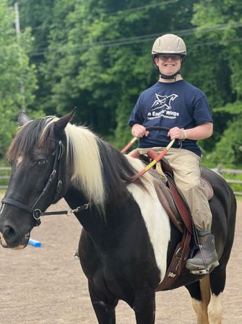 Young man rides horse
