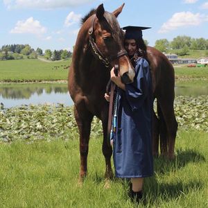 Hiba in cap and gown with horse