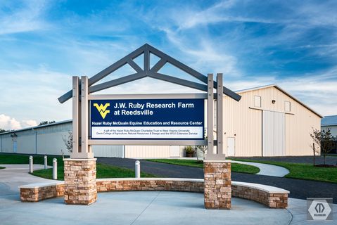 large sign that reads: J.W. Ruby Research Farm at Ruby; Hazel Ruby McQuain Equine Education and Research Center; a gift of the Hazel Ruby McQuain Charitable Trust to WVU; Davis College if Natural Resources & Design & WVU Extension Service; Manheim